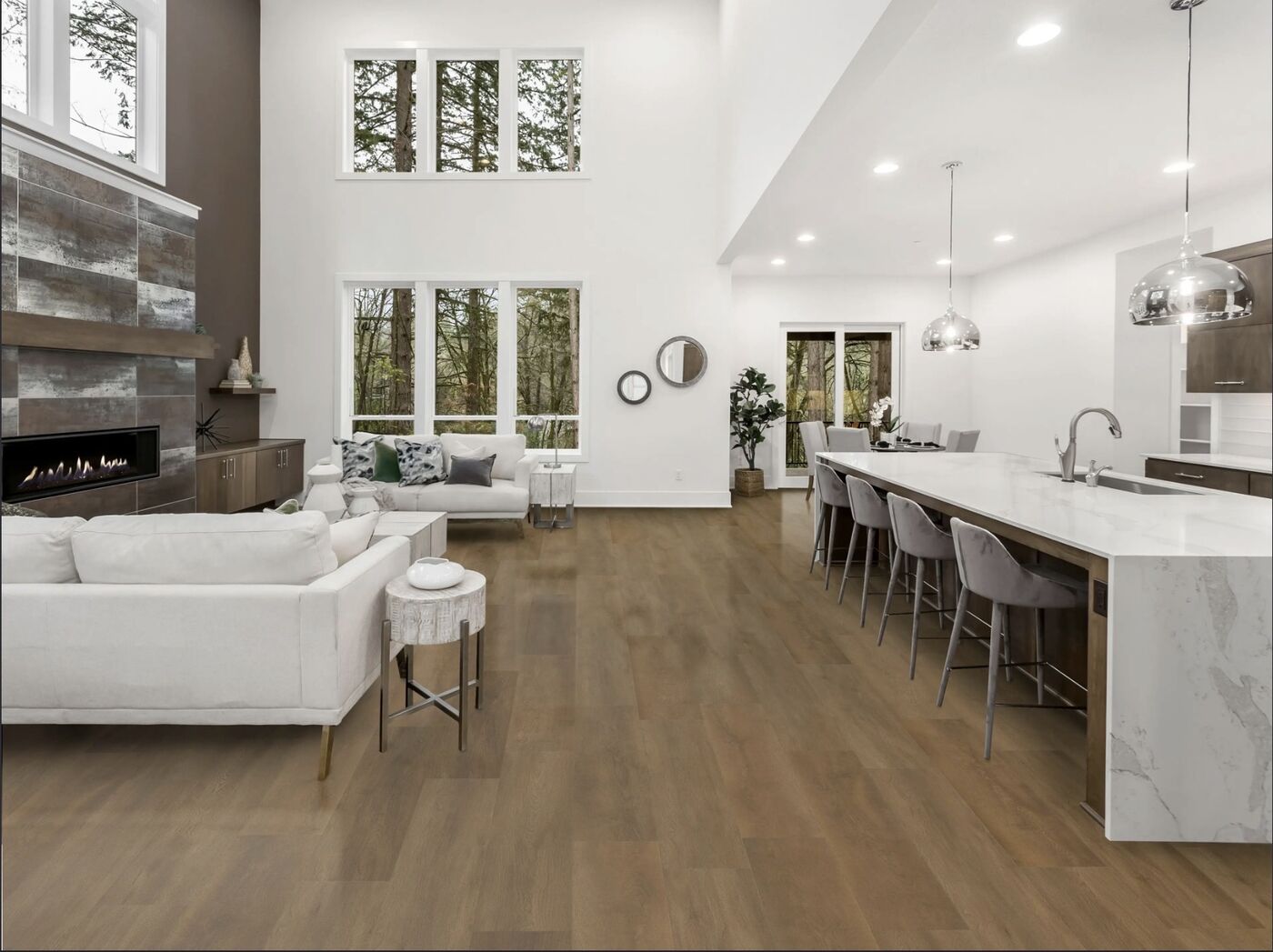 Open living and kitchen area with new wide-plank wood-look flooring